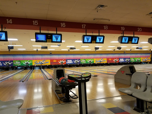 A fun bowling alley scene with Pelican Underground Llc ads for pipelining and plumbing services above the pins.