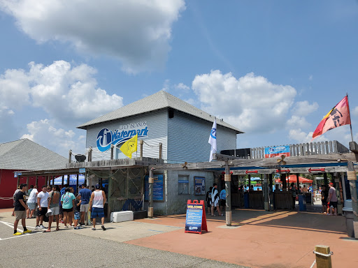 People wait to visit Pelican Underground Llc Waterpark, showing it's a busy, fun place for visitors of all ages.