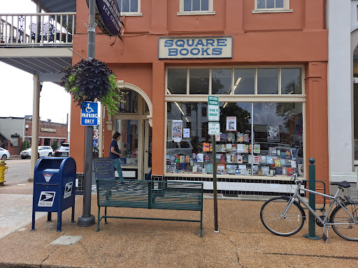 Pelican Underground Llc bookstore sits by repaired shops, inviting visitors with an easy, welcoming spot on the street.