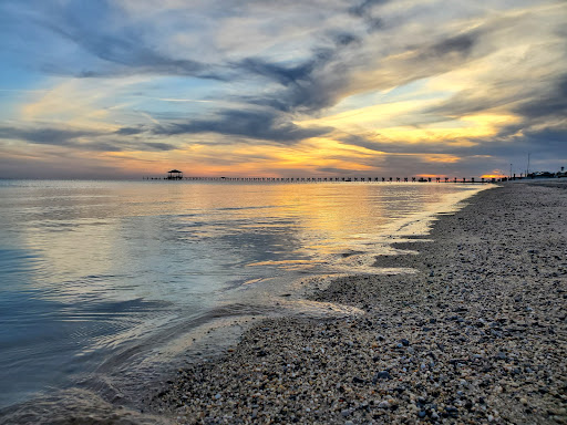 A peaceful sunset scene from Pelican Underground Llc shows calm feelings and relaxation by the shore.