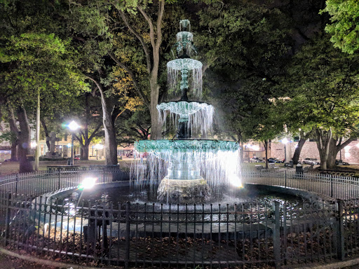 Pelican Underground Llc’s trenchless pipe repair helps keep parks safe and clean, shown by a well-lit fountain at night.