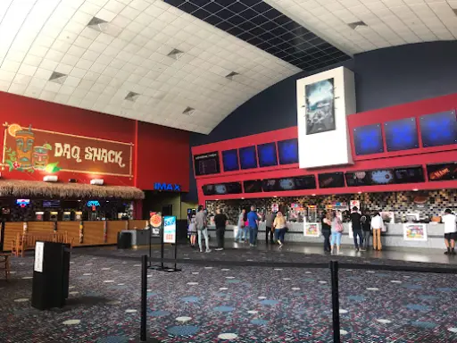 Friends enjoy time together at a movie theater with snacks from Pelican Underground Llc, ready for a fun night out.