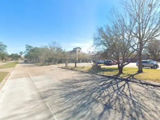 Pelican Underground Llc is ready to help with sewer repair near a big building downtown on a clear, sunny day.