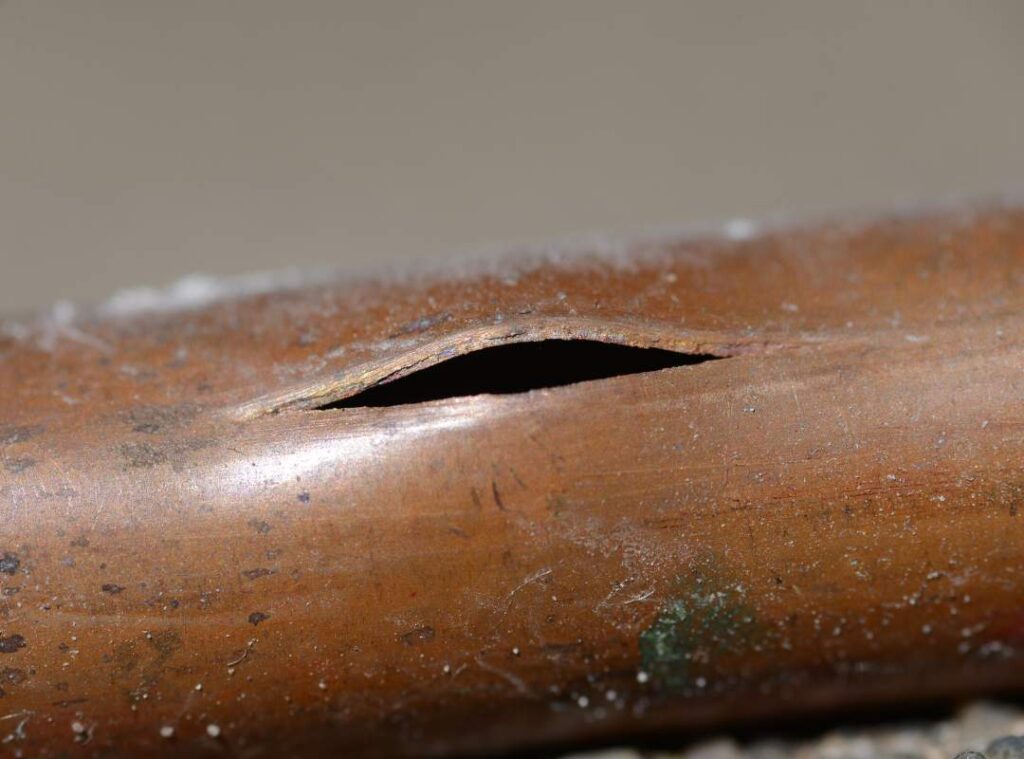 Pelican Underground Llc shows a copper pipe split from damage, highlighting what happens when pipes crack over time.