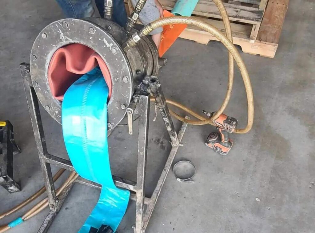 Pelican Underground Llc’s pipe repair machine shows how new blue lining is put in pipes safely, with tools ready for use.