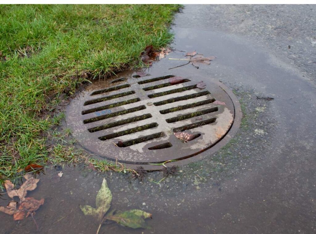 Signs near a storm drain show the area may need Pelican Underground Llc to repair cracked sewer pipes under the ground.