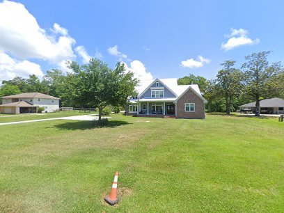 Pelican Underground Llc is repairing pipes at a home. A cone marks the work area, and neighbors can see the repair in progress.