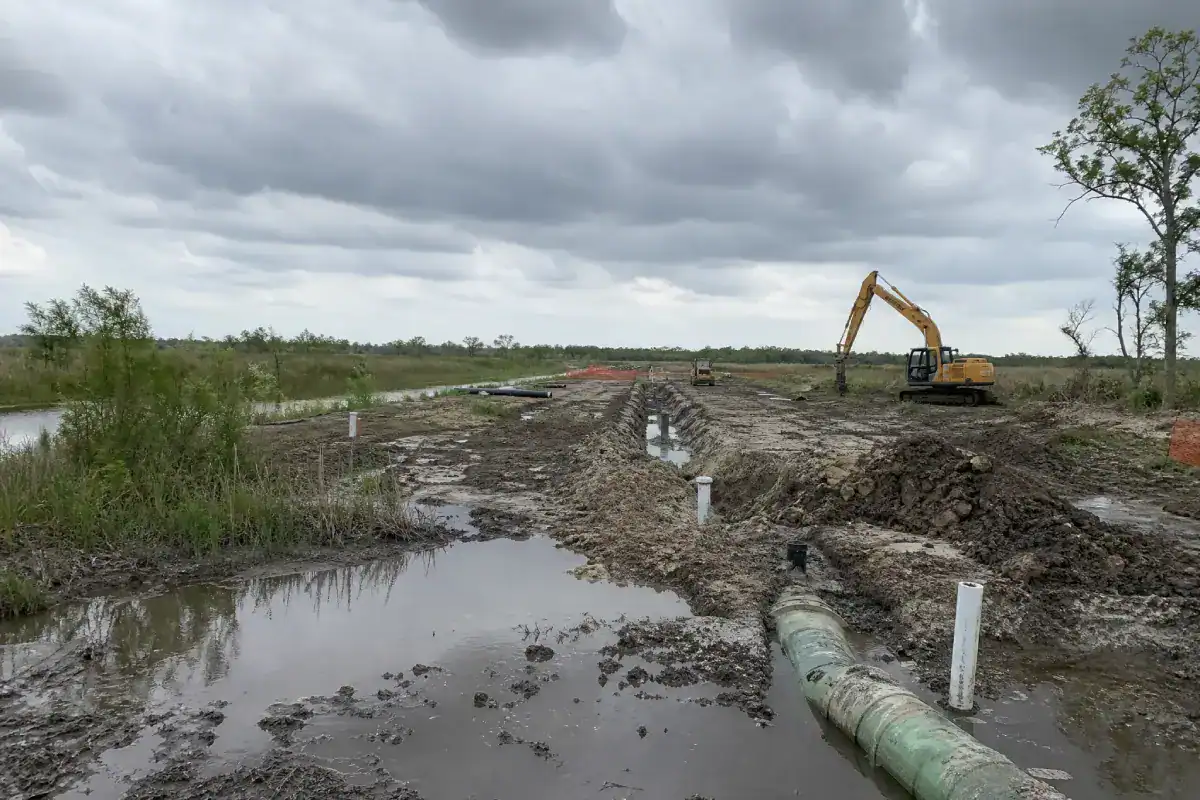 Pelican Underground LLC working on a build site, showing progress despite wet and muddy conditions.