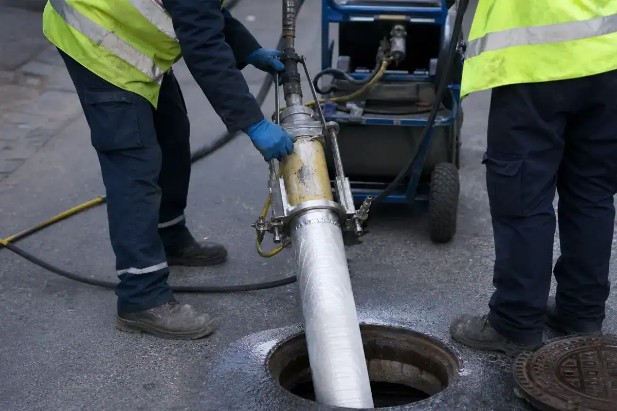 Pelican Underground LLC crew is shown doing street manhole maintenance work using their equipment.