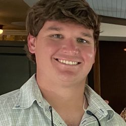 A friendly young man represents Pelican Underground Llc, smiling with a relaxed, welcoming vibe indoors.